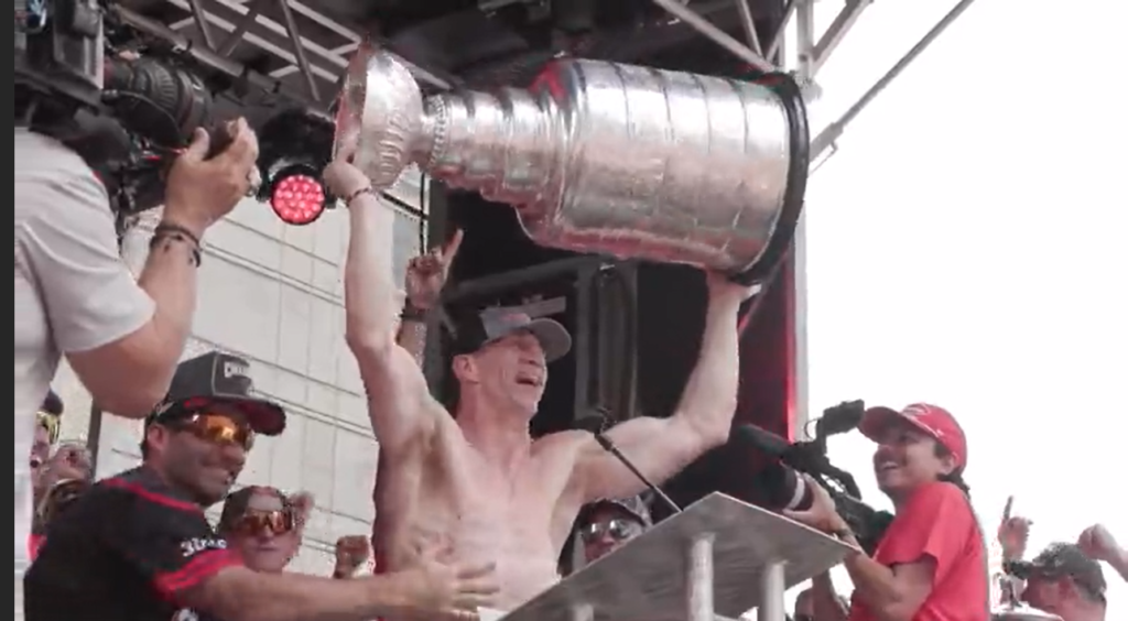 Rod Brind'Amour holds the his second Carolina Hurricanes Stanley Cup over his head at the championship rally in Raleigh.