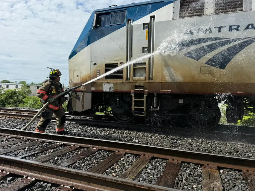 Durham firefighters hosing debris off of Amtrak train (Photos courtesy of the Durham Fire Department)