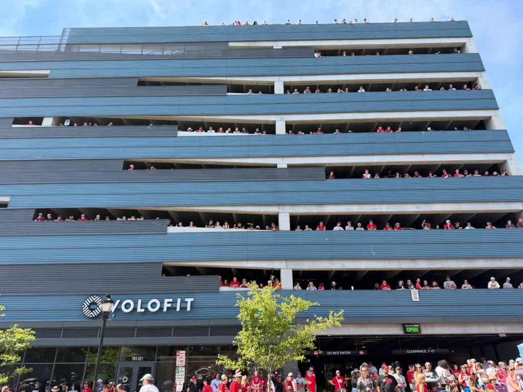 A parking garage in Raleigh is filled with people looking to catch a glimpse of the passing parade. (Harrison Grubb)