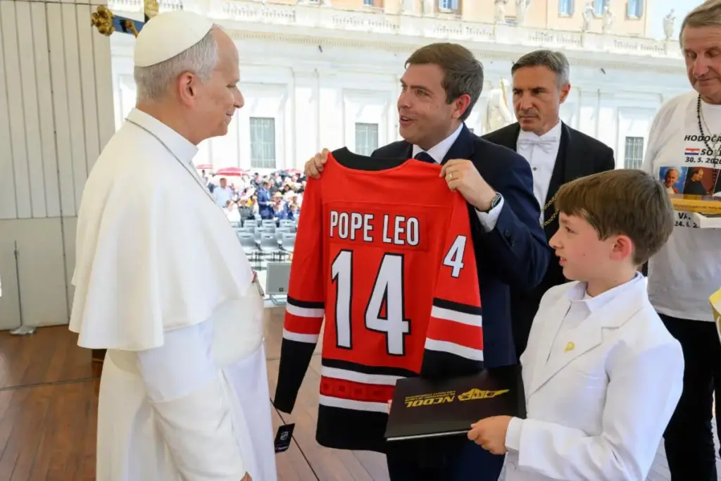 NC Labor Commissioner Luke Farley presents Pope Leo XIV with a championship Carolina Hurricanes jersey. (Photo courtesy of NCDOL and Vatican Media)