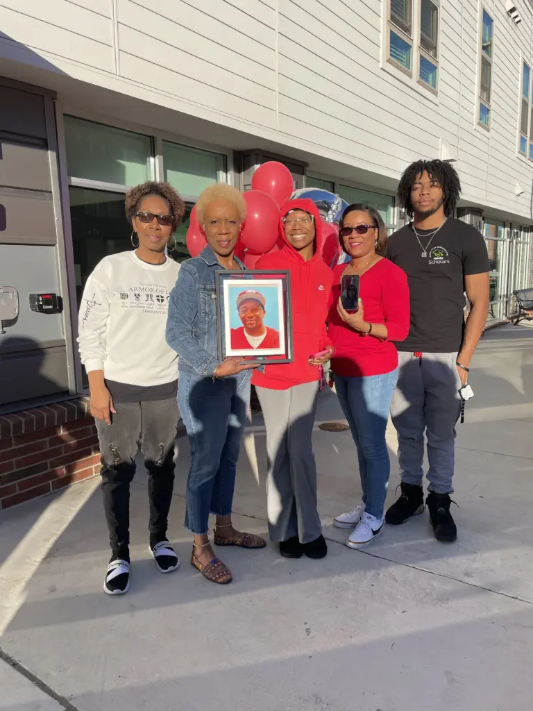 Debra Davies, center and holding a picture of Jason Pulliam, with family and friends at a memorial balloon release for Pulliam. (Debra Davies)