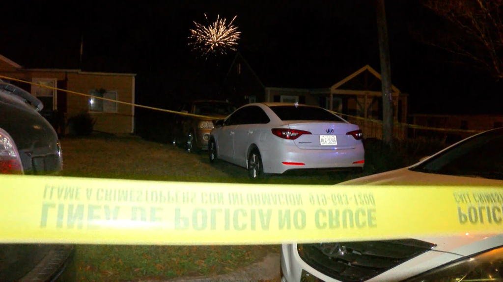 A crime scene in Durham with a firework going off in the background. (CBS 17)