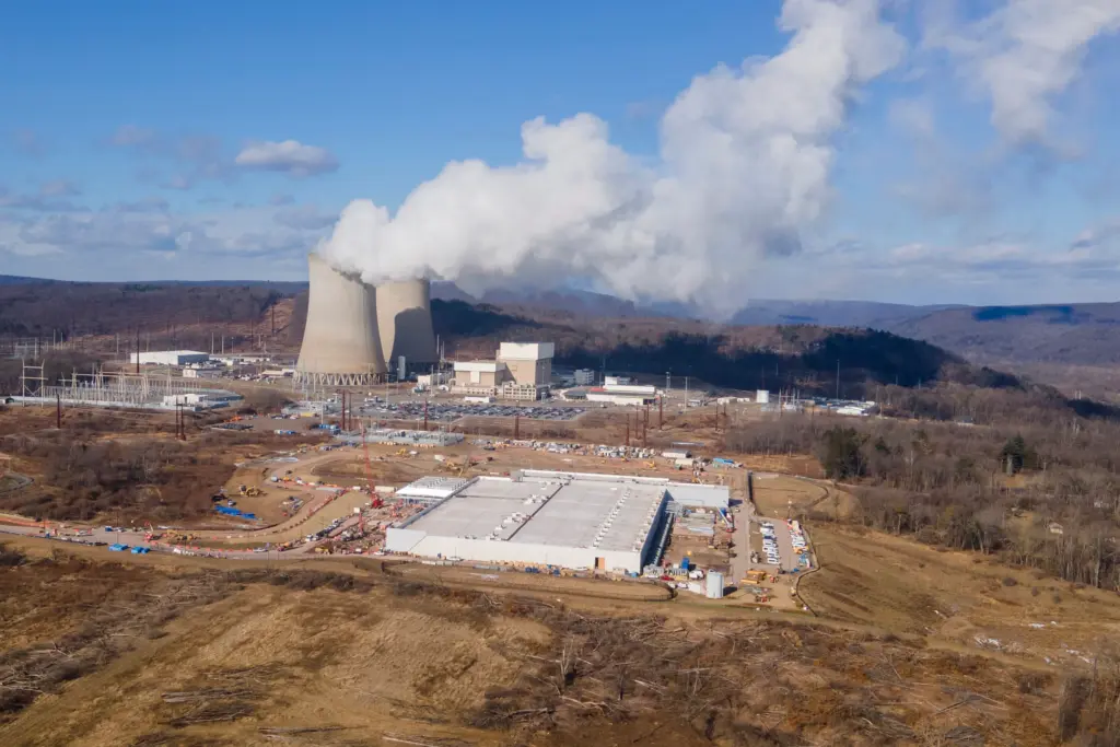 FILE - A data center owned by Amazon Web Services, front right, is under construction next to the Susquehanna nuclear power plant in Berwick, Pa., on Tuesday, Jan. 14, 2024. (AP Photo/Ted Shaffrey, file)
