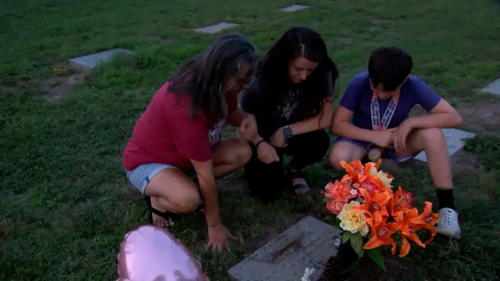 Tina Goodwin (left), Macy Grace Ditty's paternal grandmother, visits Macy's grave. (Justin Moore)